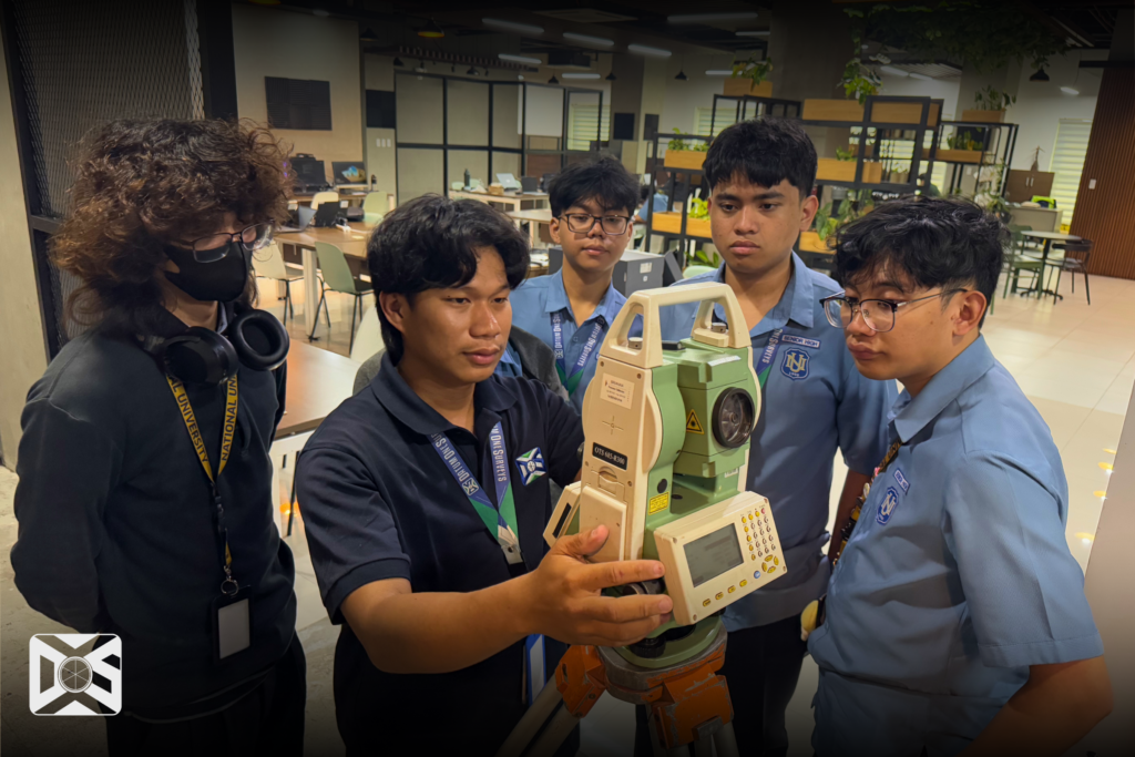 A Geodetic Engineer in Datum One Surveys demonstrate how to use a Total Station to the NU Fairview SHS Students
