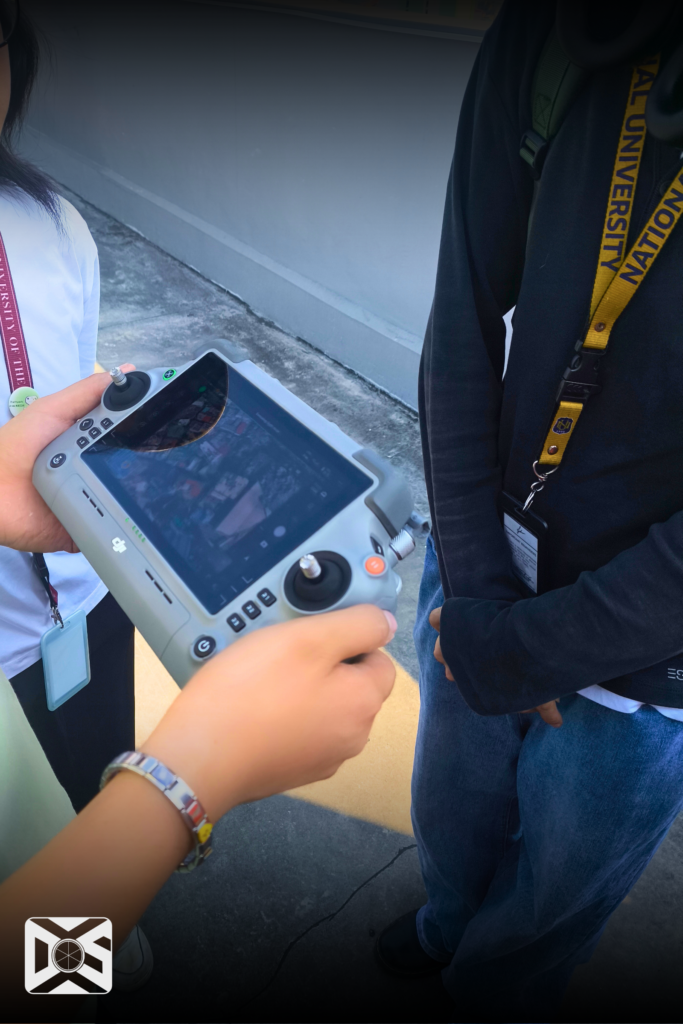 A Drone Pilot holding a Remote Controller to monitor the drone 