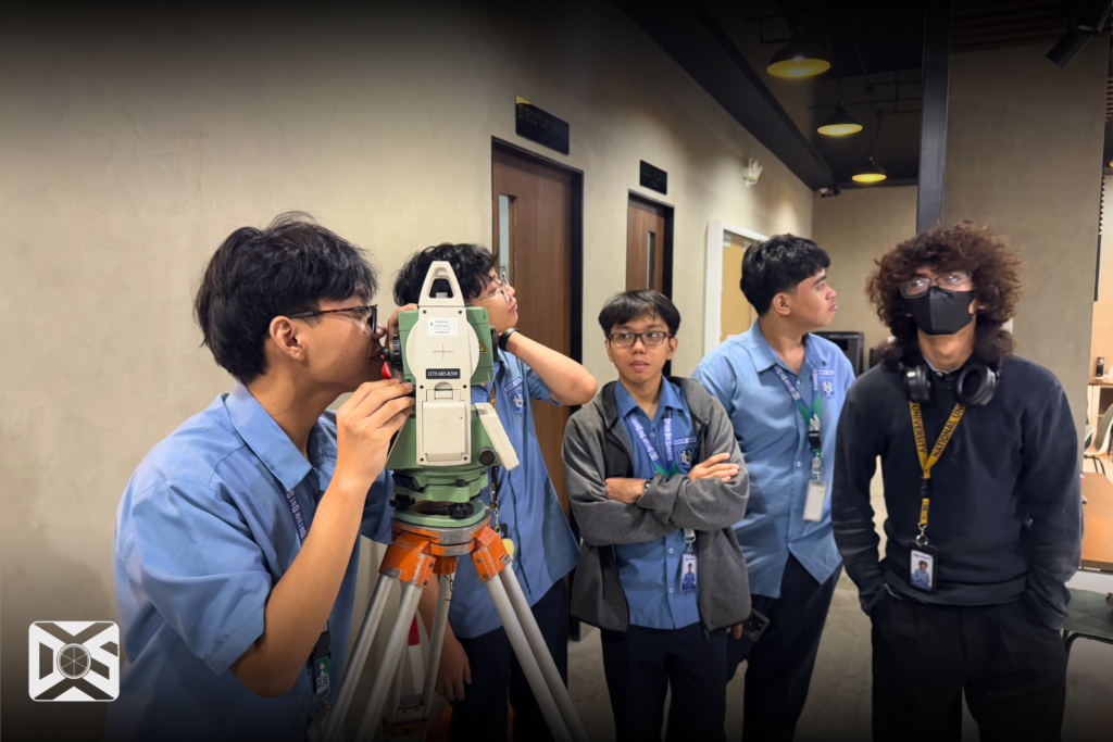 An NU Fairview SHS Student using a Total Station 